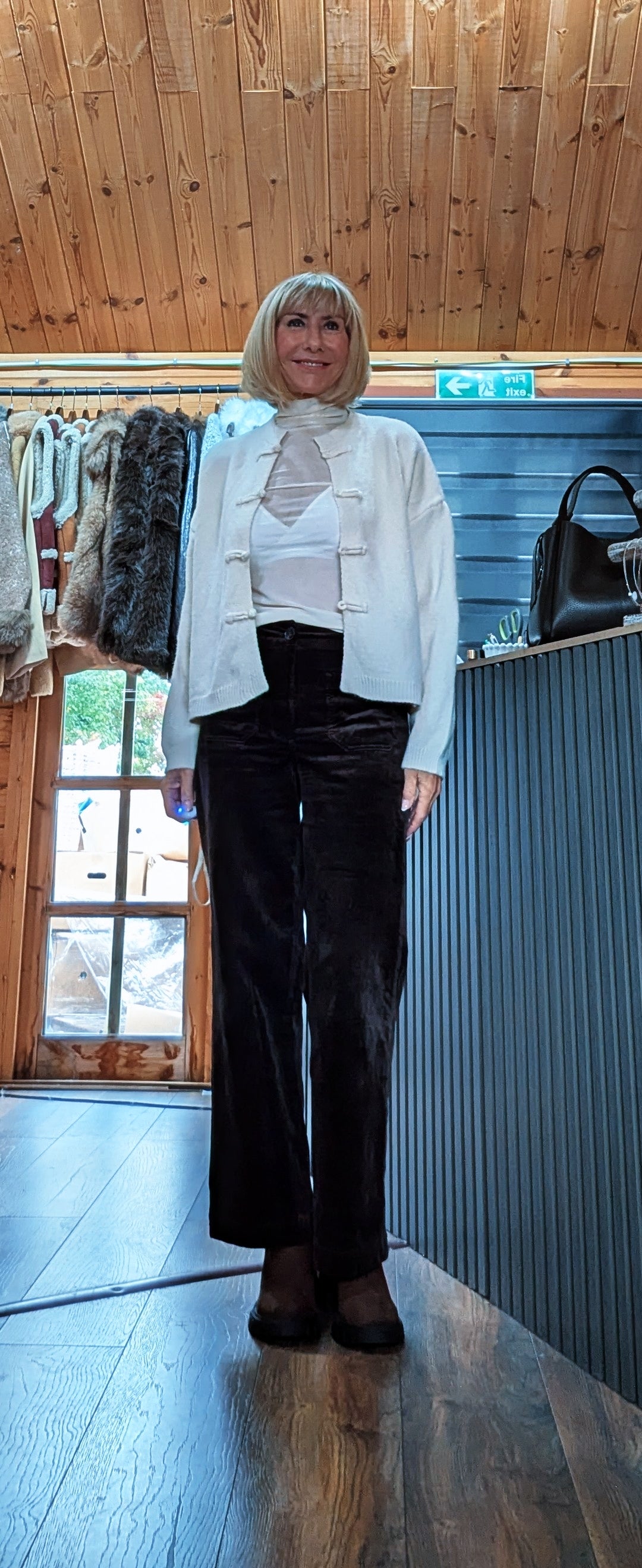 Full-length view of Fran cardigan worn partly open over a white top and dark trousers