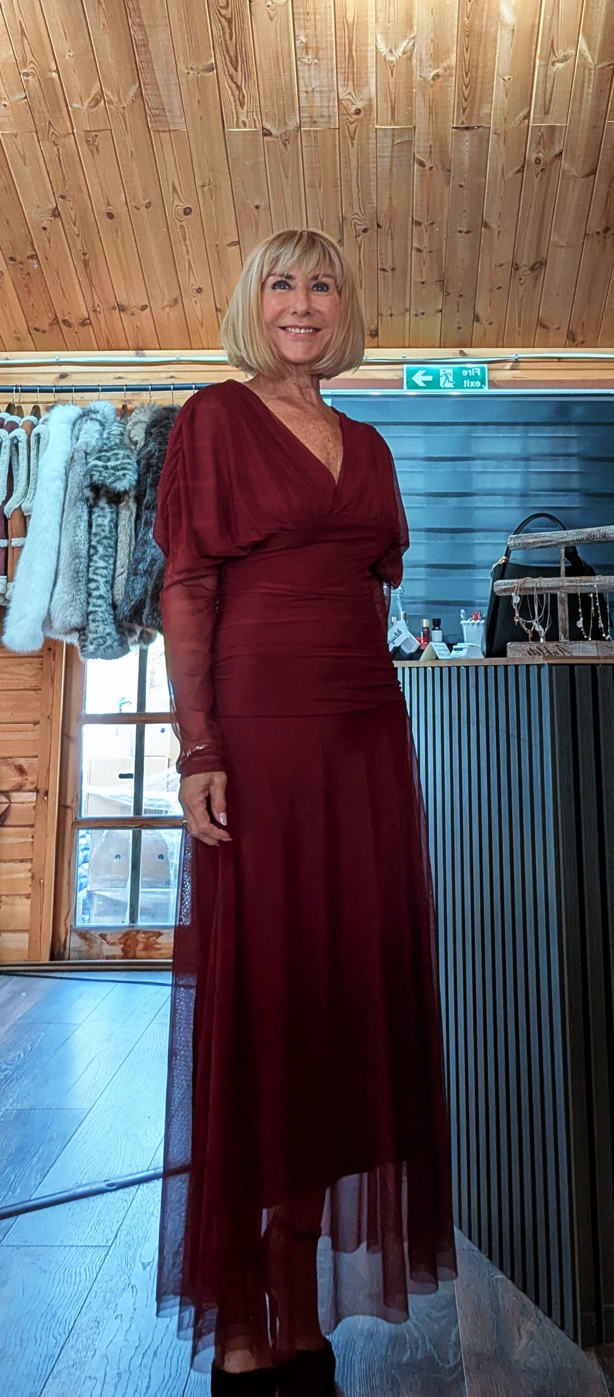 Luna burgundy dress modelled at an angle, showing the long tulle overlay