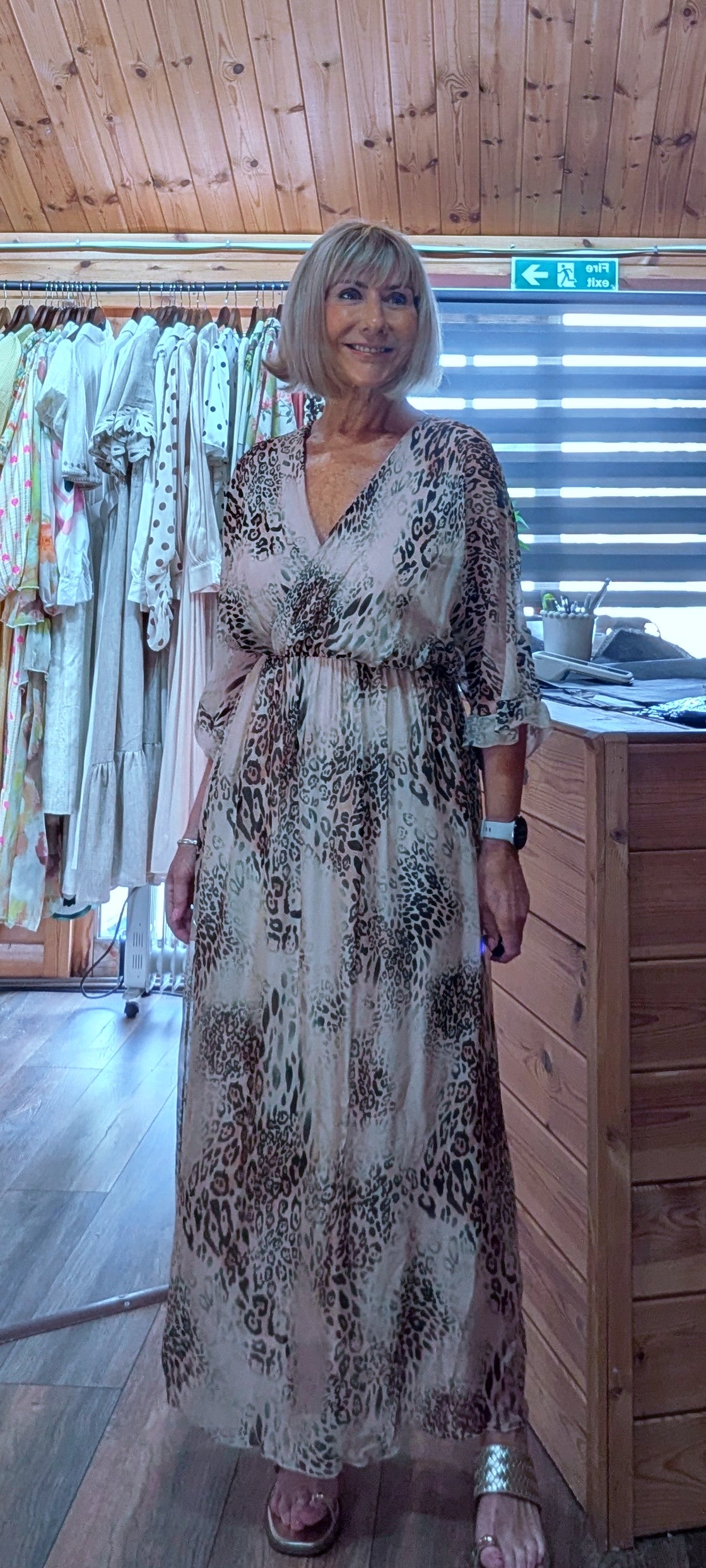 Elegant brown leopard print silk blend dress with a flattering V-neck, elasticated waist and flowing full-length skirt.