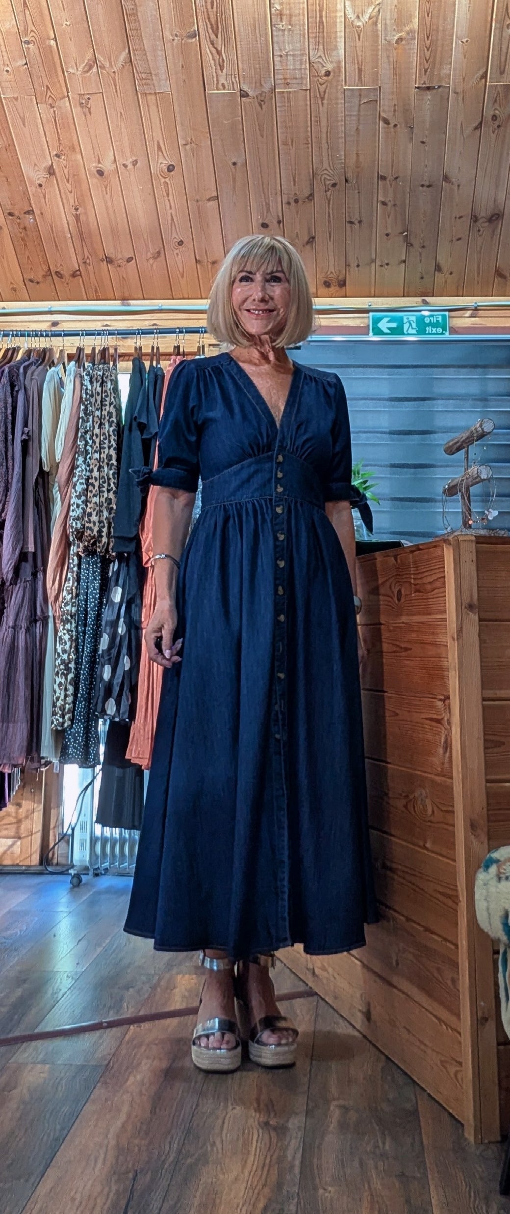 ditsydi wearing a dark navy blue midi dress with short sleeves, a V-neckline, and a button-down front UK boutique 