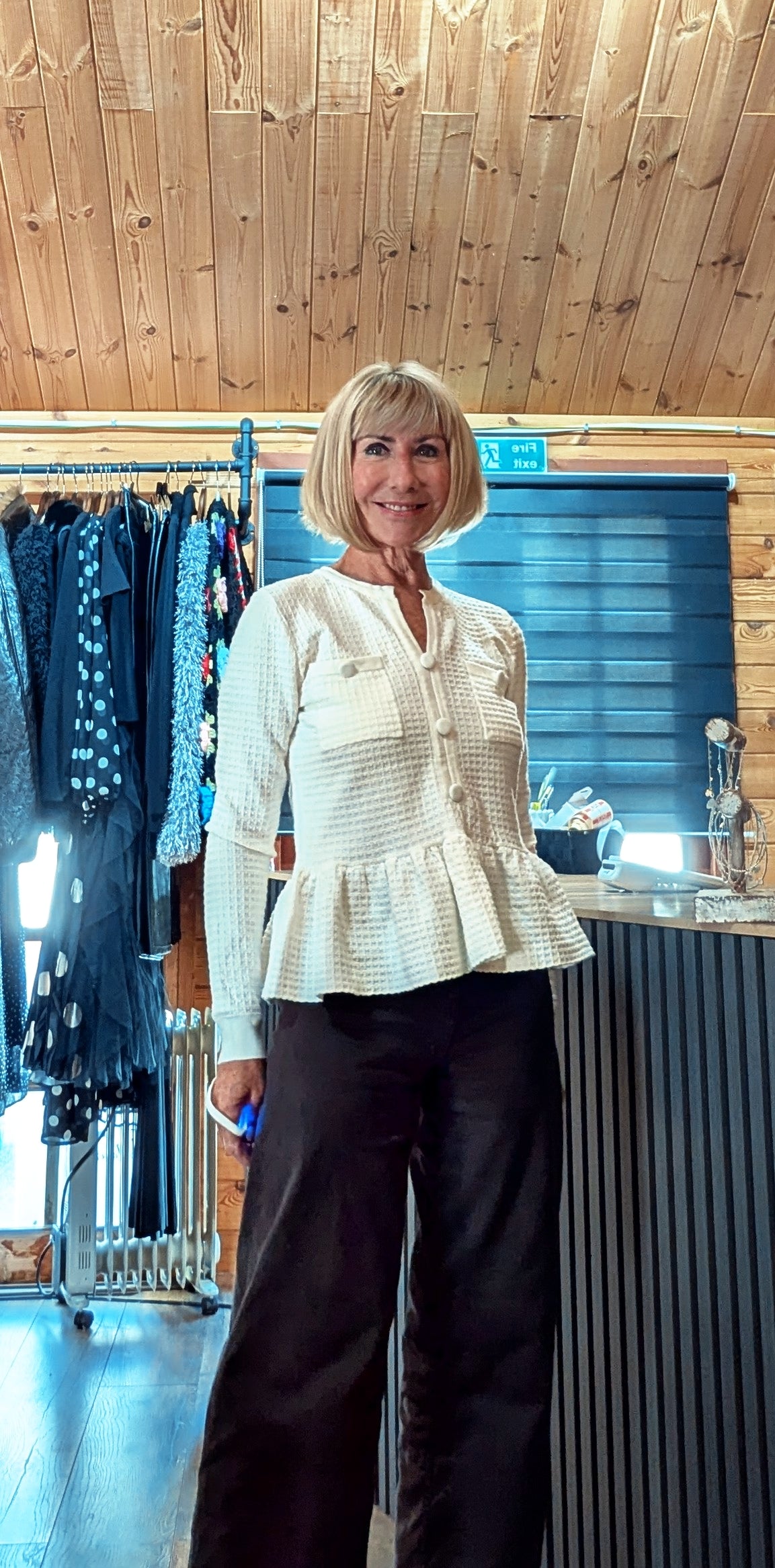 Ivory women’s knit  with round neckline and peplum detail