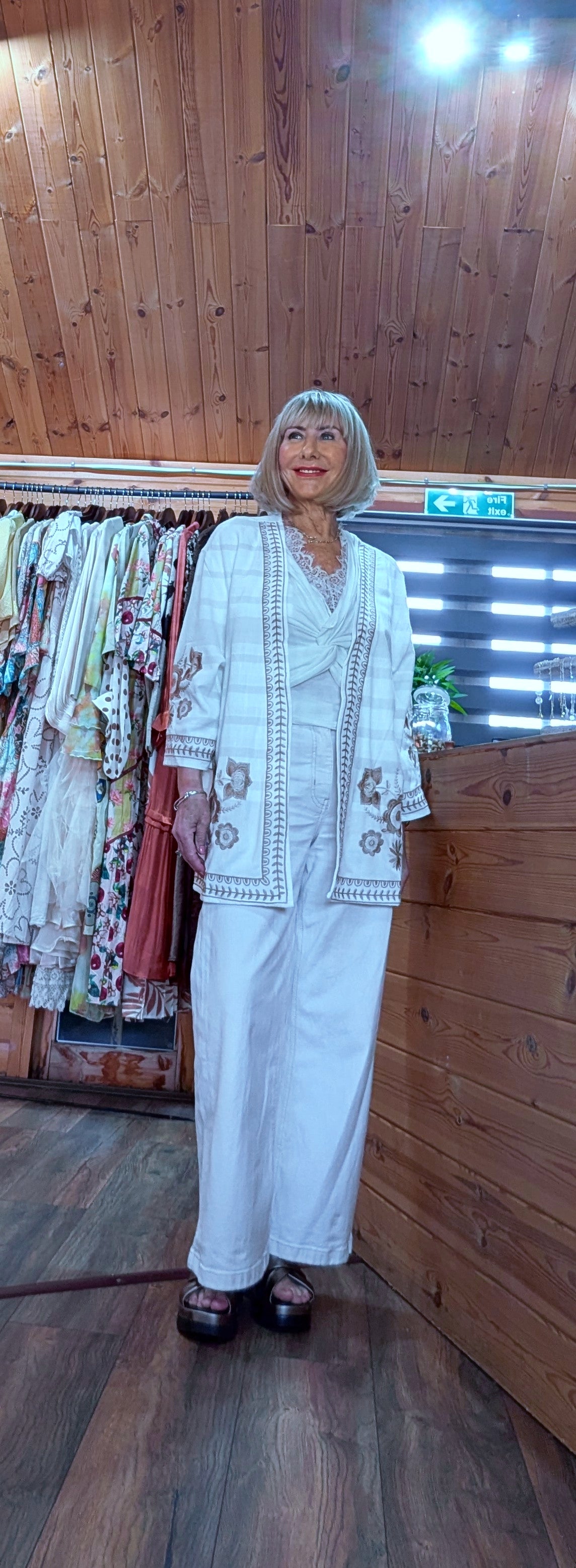 White embroidered kimono-style jacket worn as a summer layer