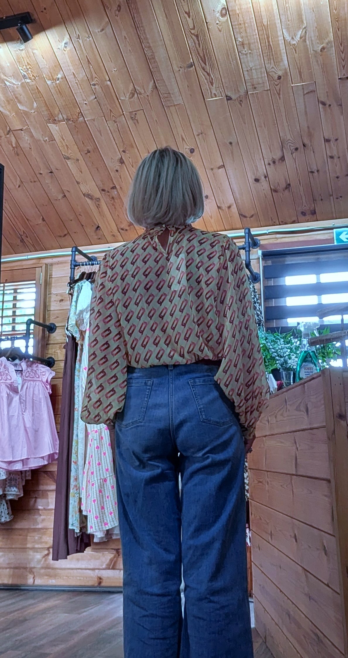 Rear view Boutique floral blouse with decorative flower appliqué, V-neck and balloon sleeves