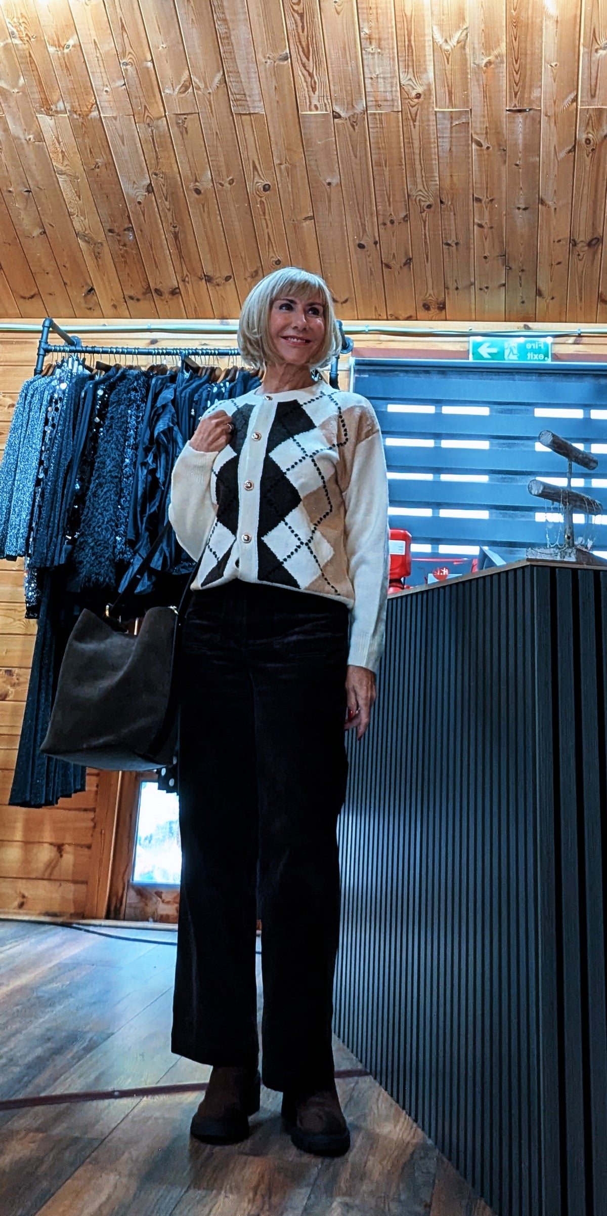 Irene ivory argyle cardigan styled with a black shoulder bag and boots
