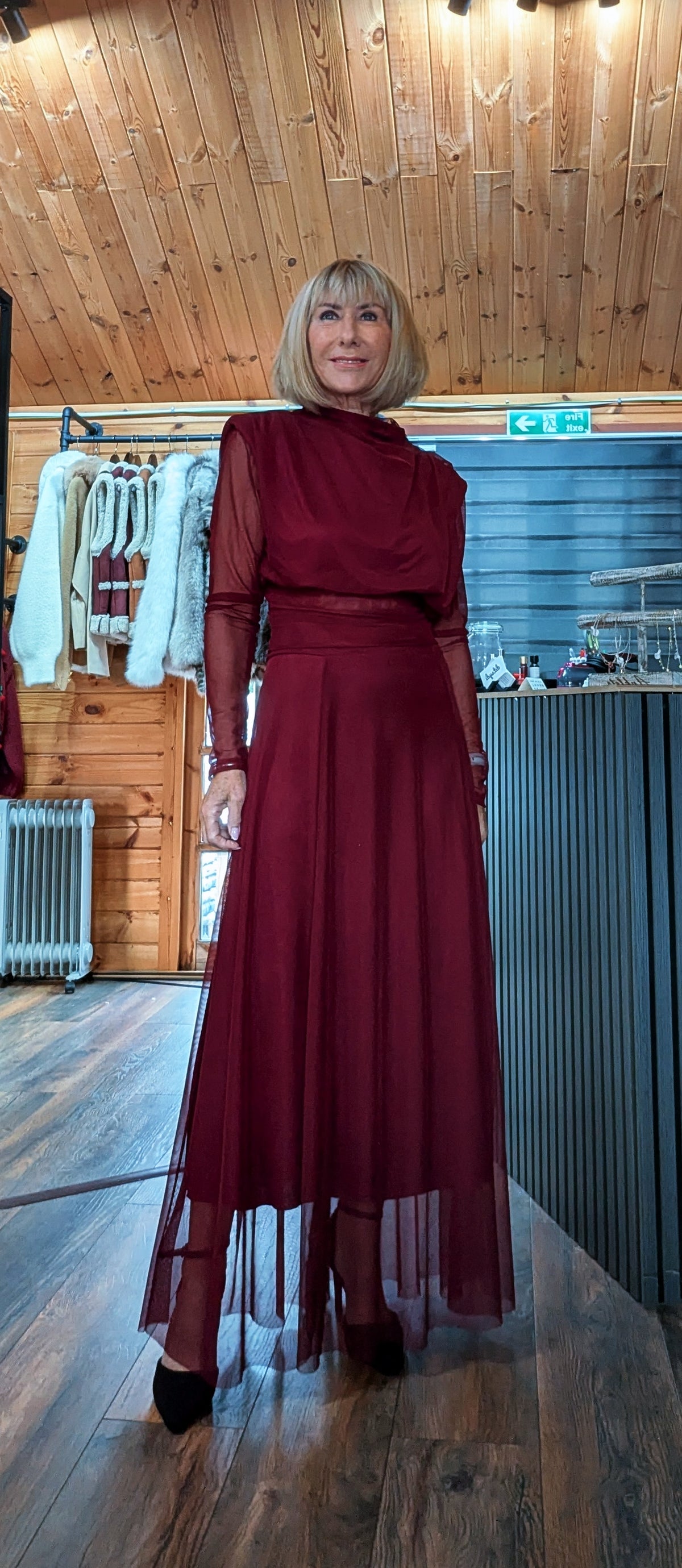 Full-length front view of Harlow burgundy top and skirt set with a sheer skirt overlay