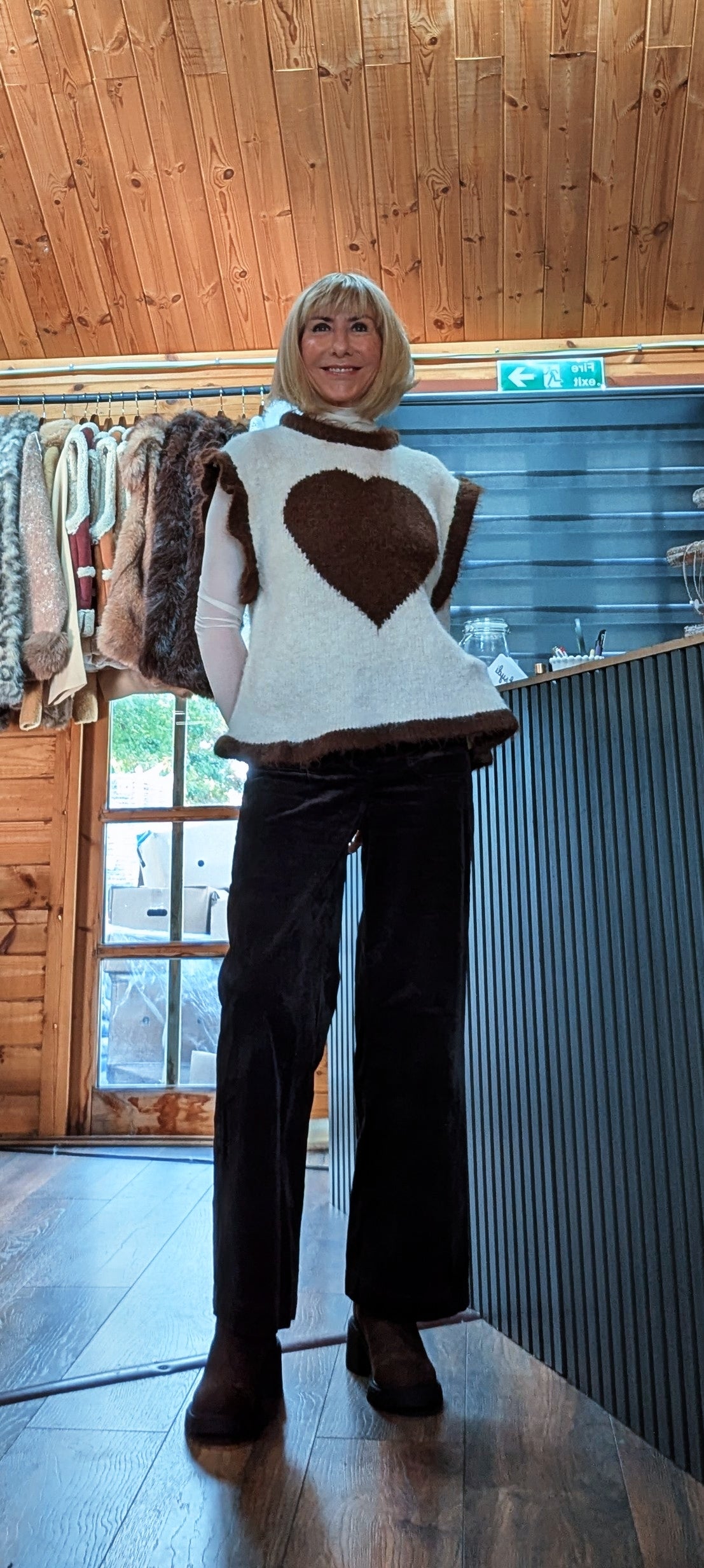 Full-length view of Maura beige sweater with a chocolate heart and frilled hem