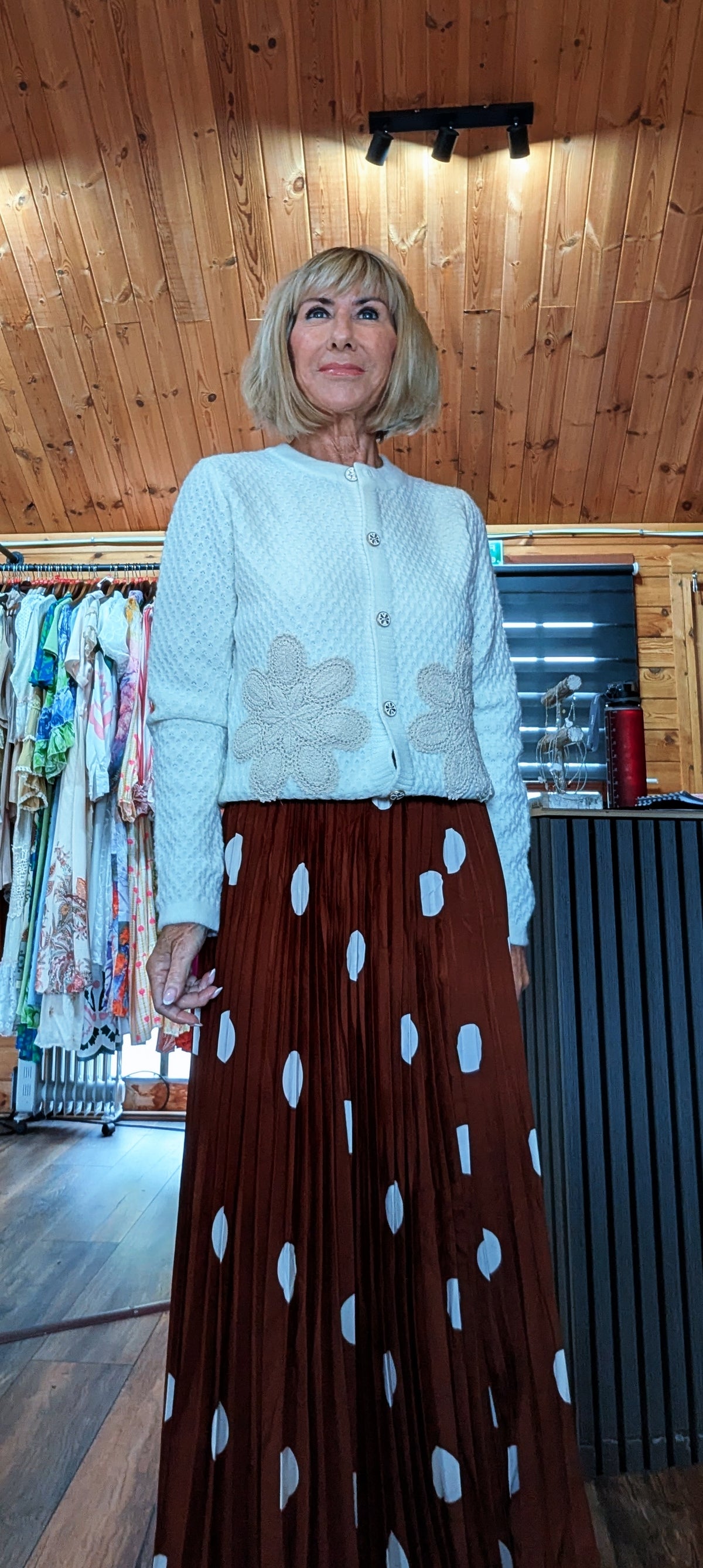 Close up of Aviary white embroidered cardigan with long sleeves and gold button detail.