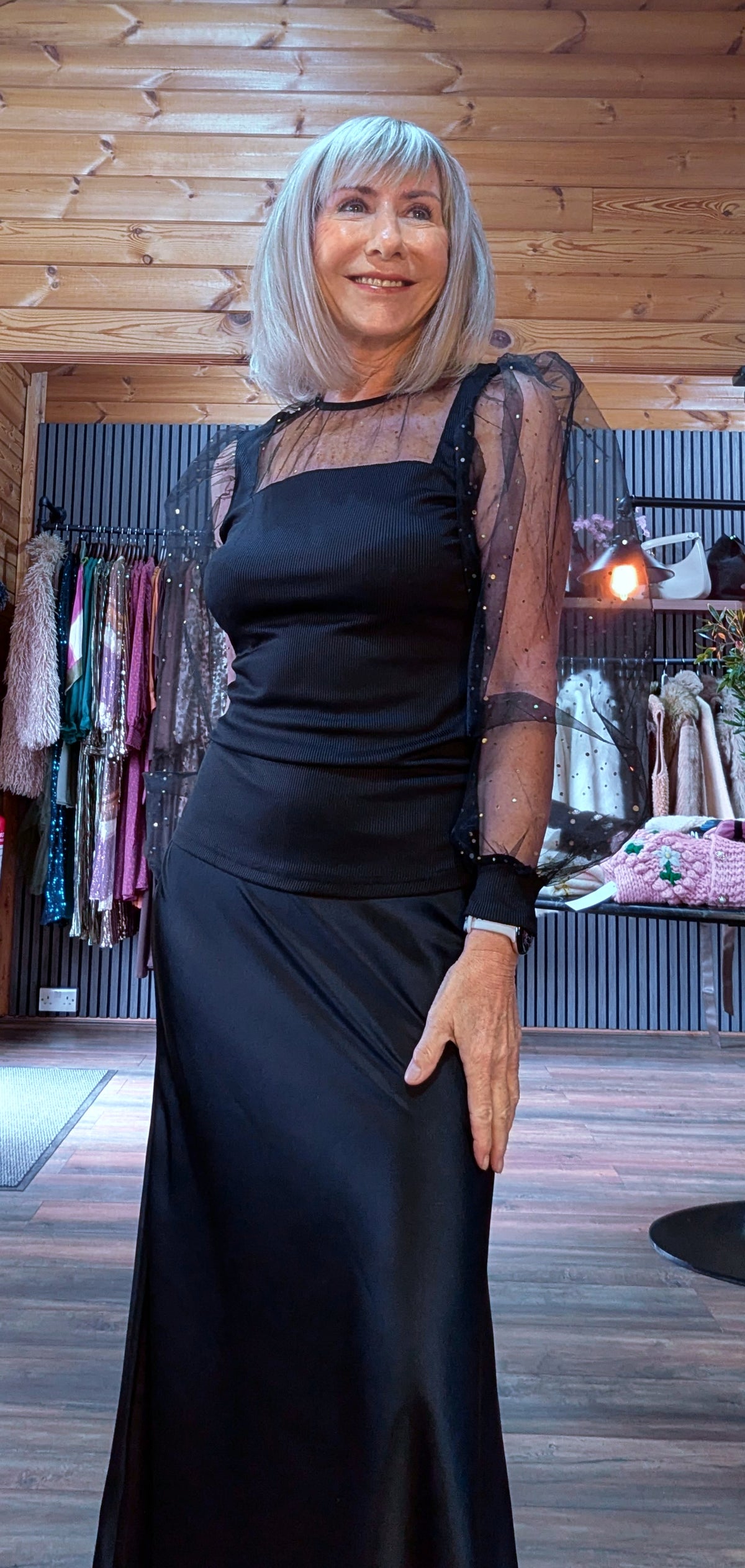 Sia sparkle top worn with a black skirt, showing the fitted bodice and organza sleeves