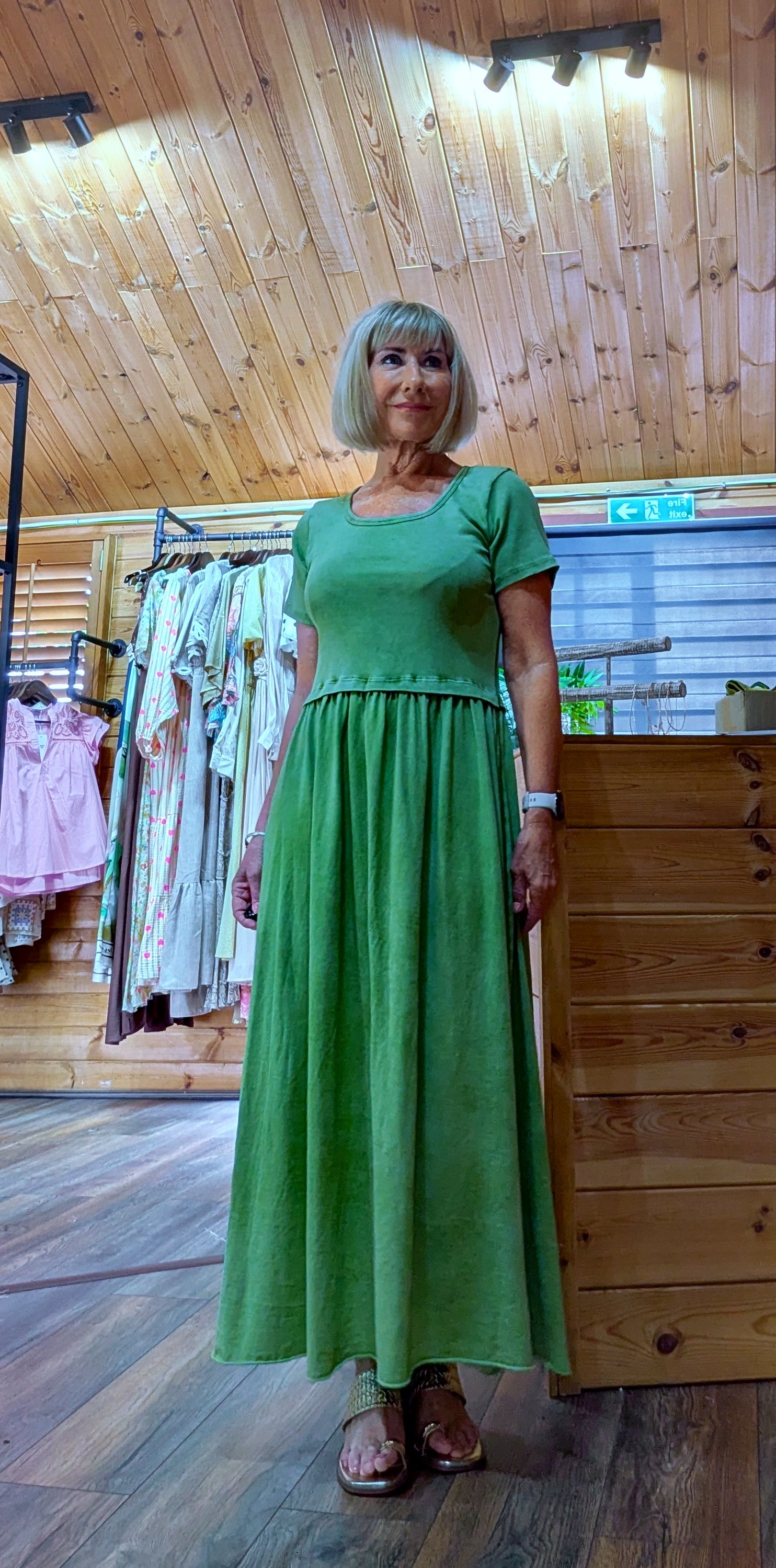 Ditsydi wearing Ursula casual green dress with gold sandals