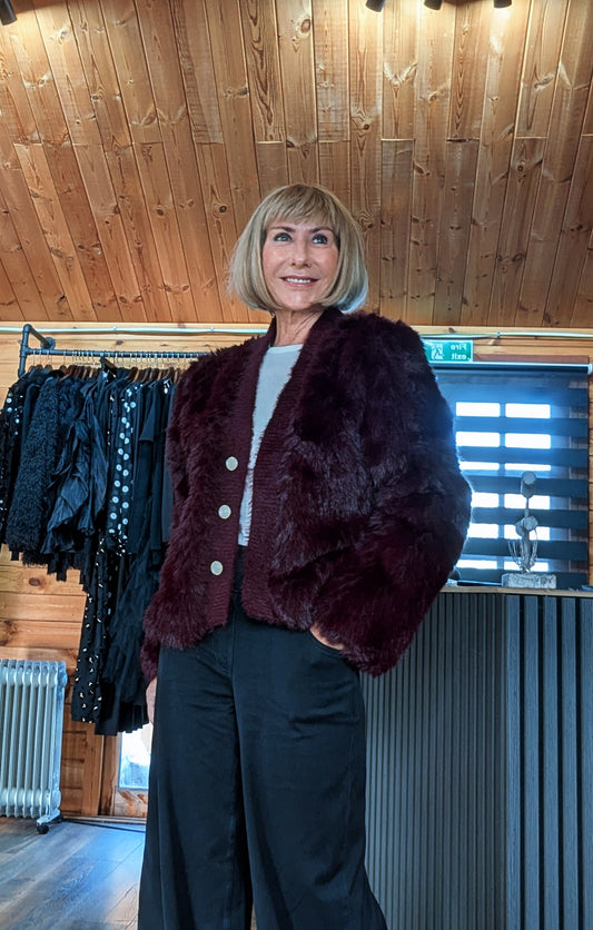 Closer view of Di wearing the Lumi burgundy faux fur jacket over a pale top