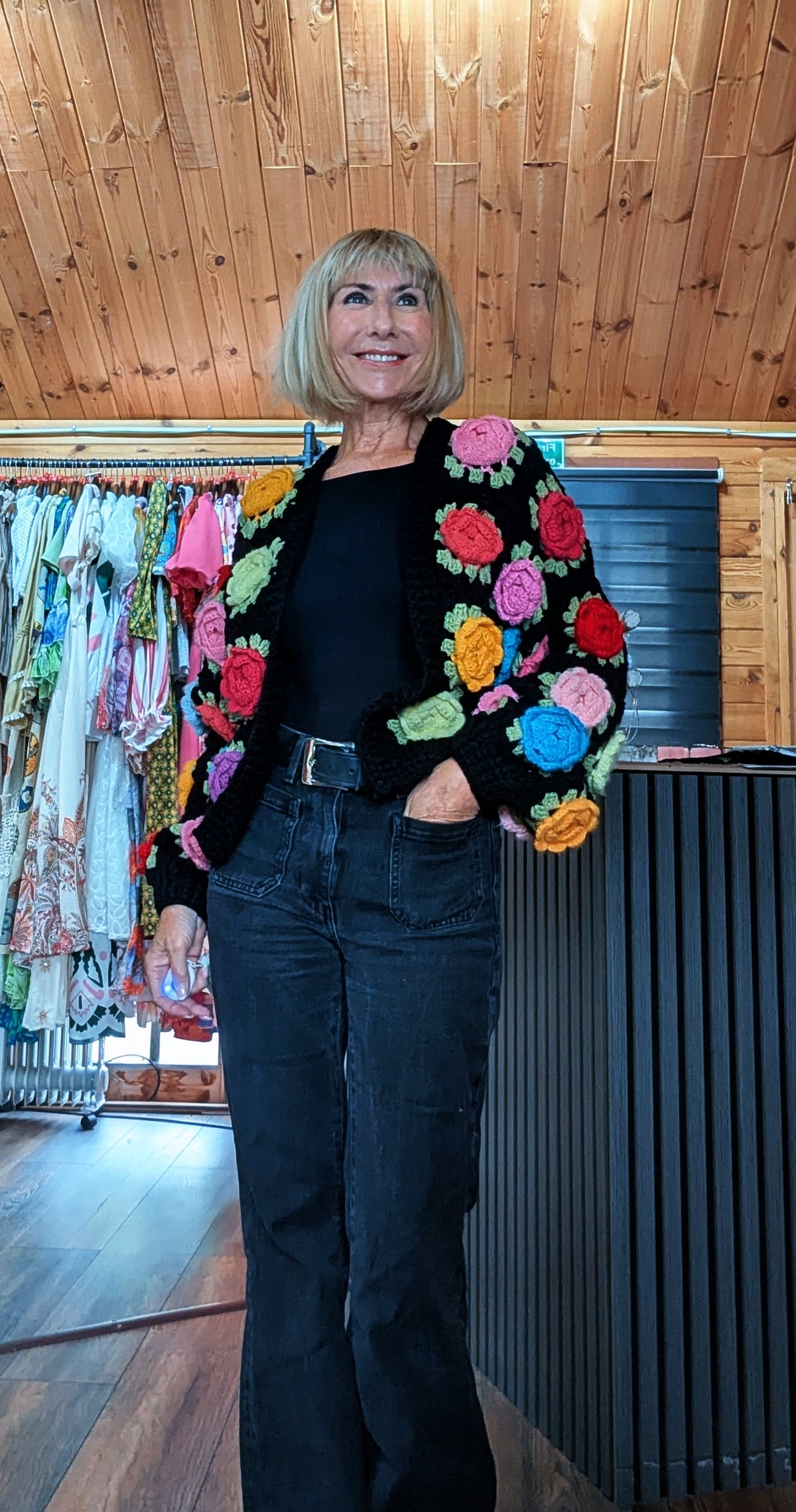 Women’s black open-front crochet cardigan decorated with raised 3D flowers
