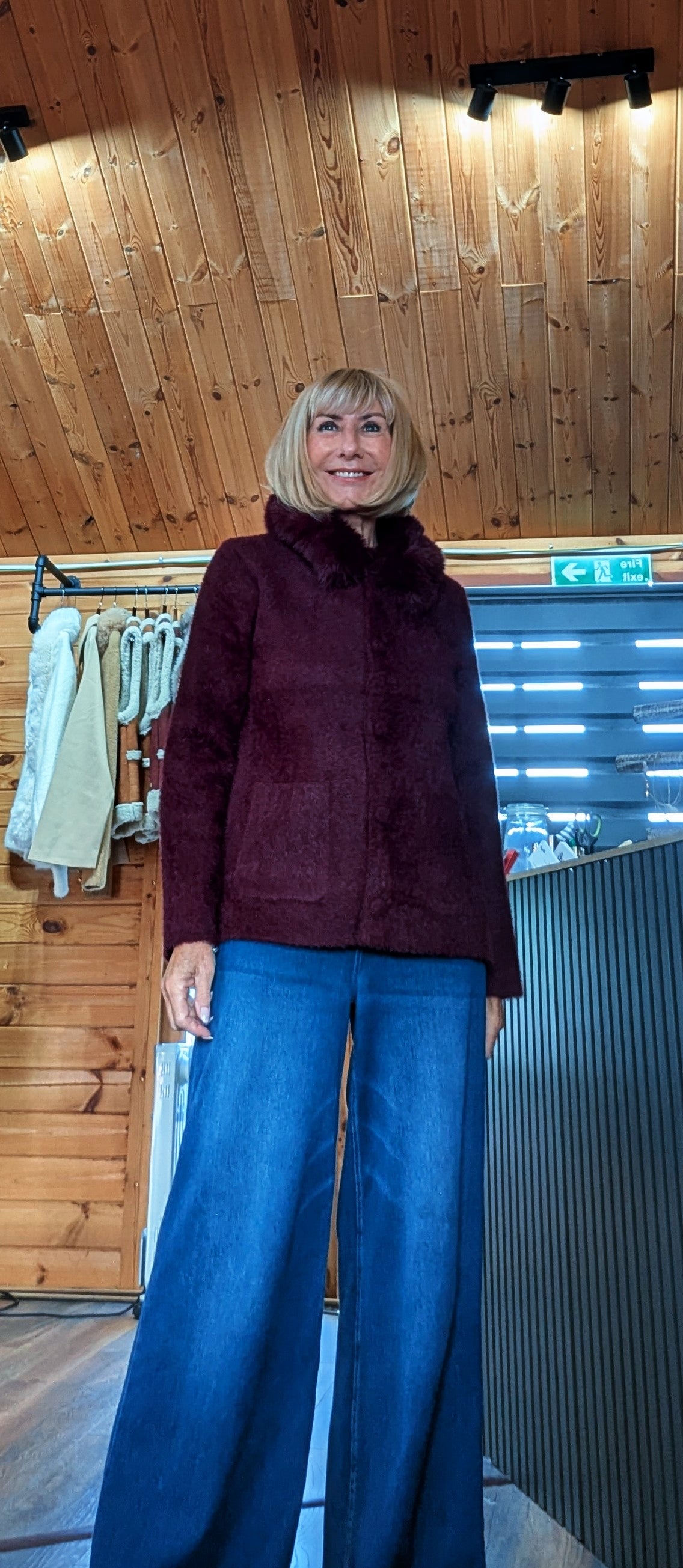 Close up of ditsydi wearing Amaryllis burgundy soft knit cardigan with pockets