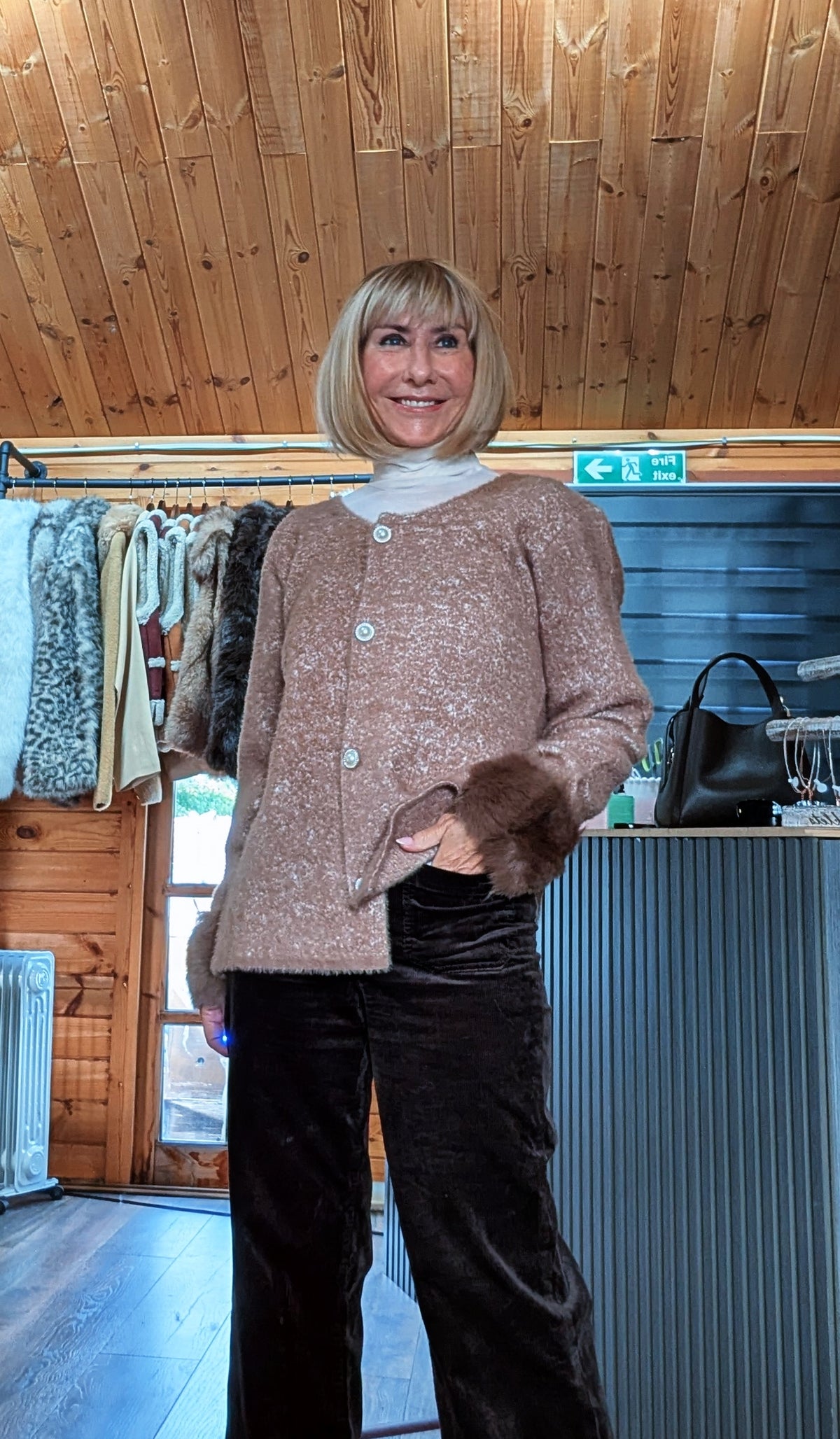 Closer view of Liv chocolate cardigan fastened at the front with matching brown faux fur cuffs