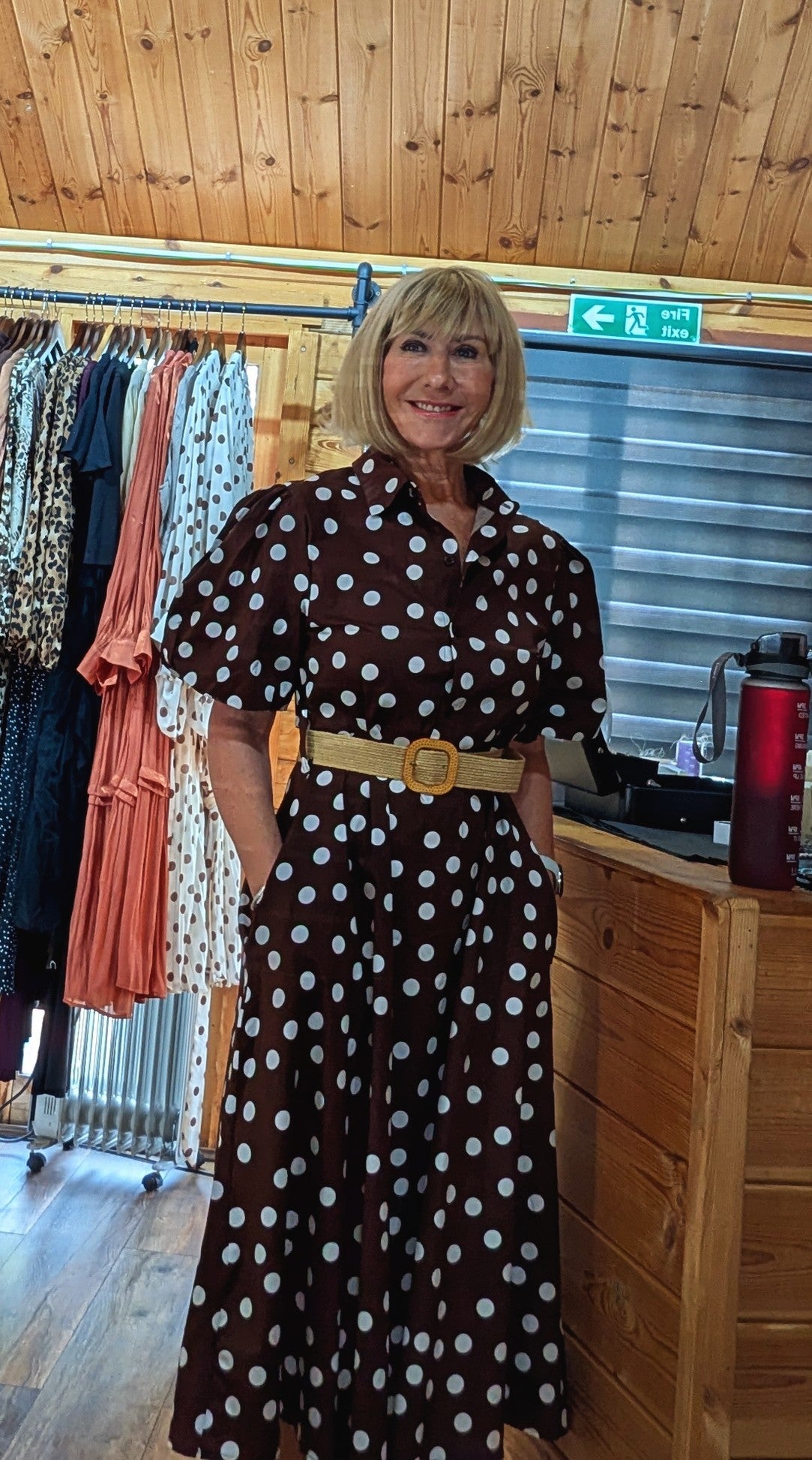 Aoife vintage-inspired brown midi dress styled with a woven belt.