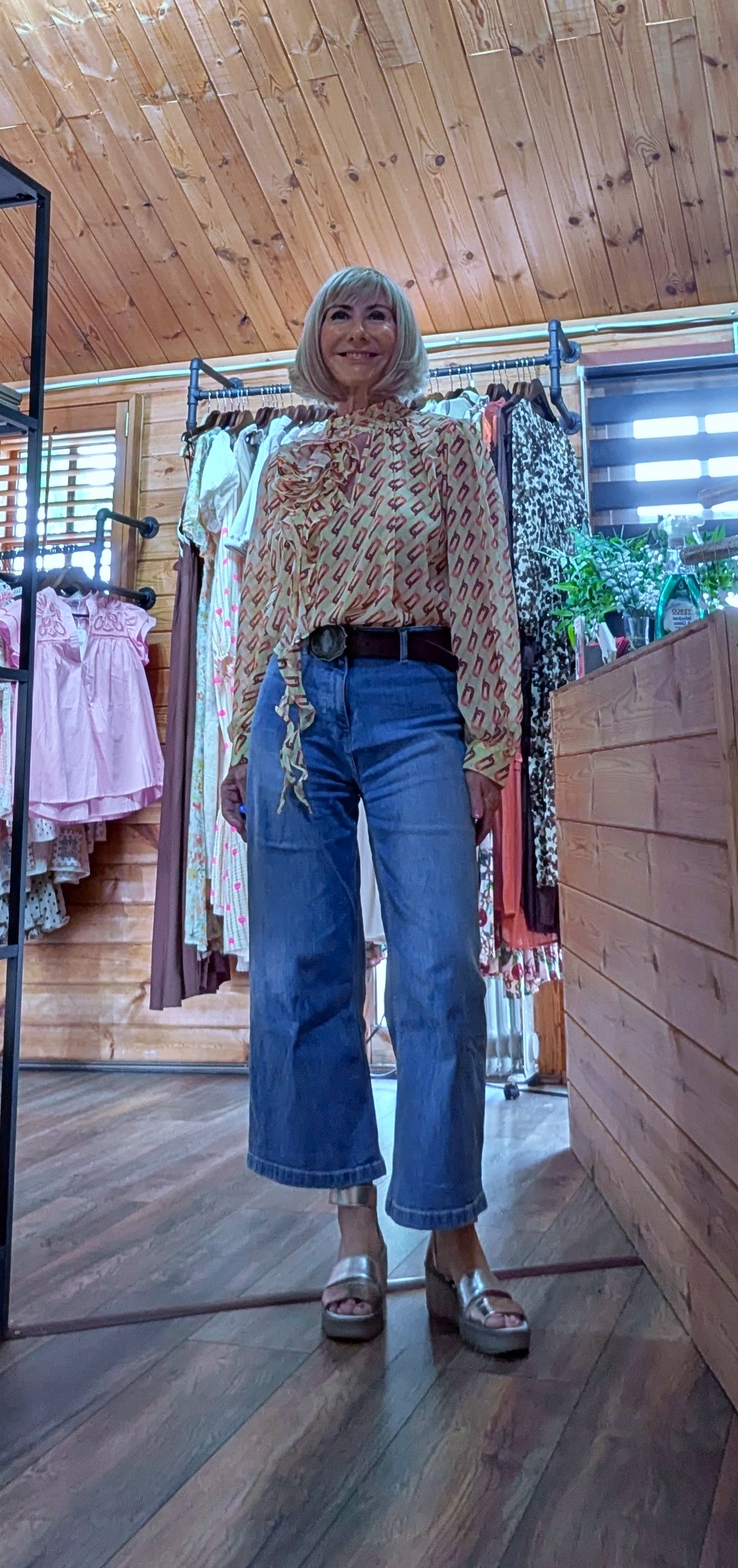 Model wearing the Emery floral detail blouse styled with  cropped wide leg