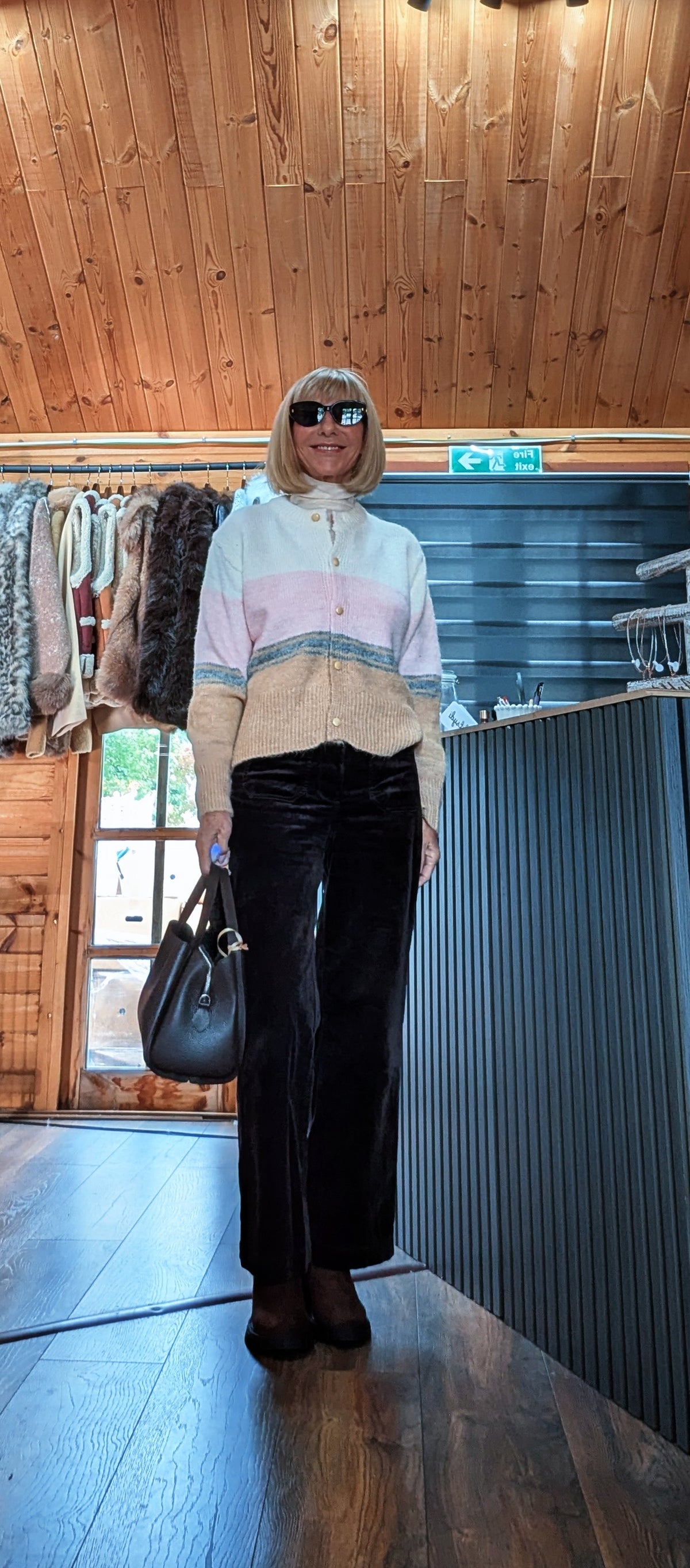 Helen striped knit cardigan styled with sunglasses, dark trousers and a black handbag at the side