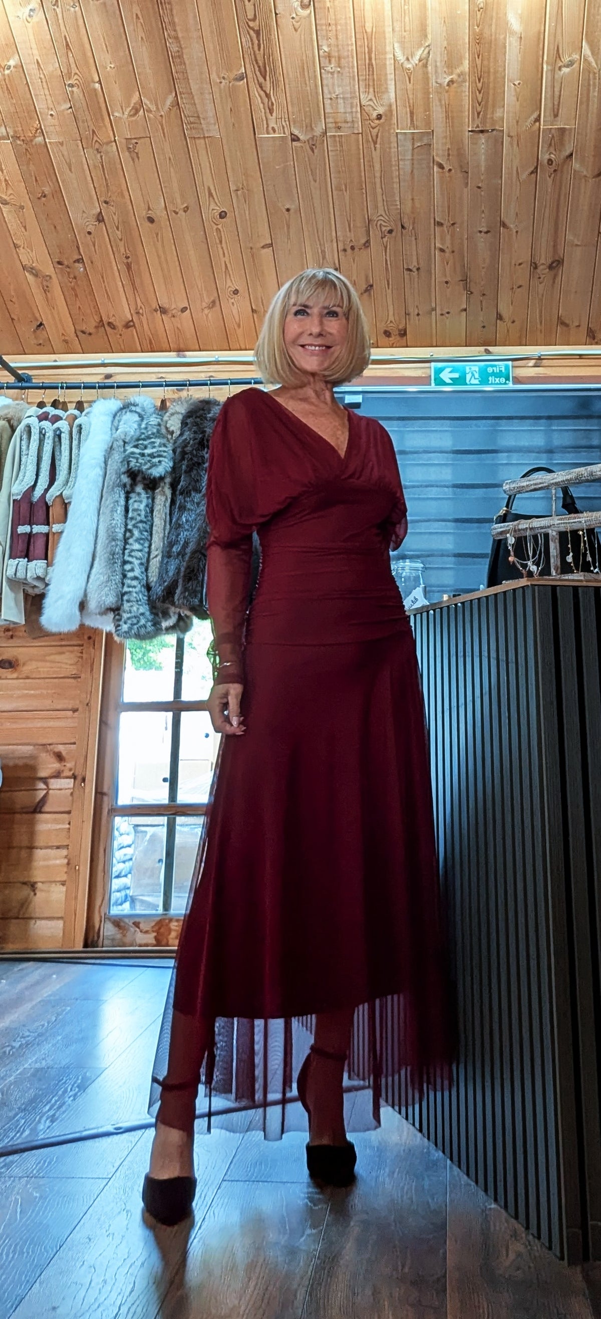 Luna burgundy tulle dress modelled with black heels, showing the sheer skirt hem