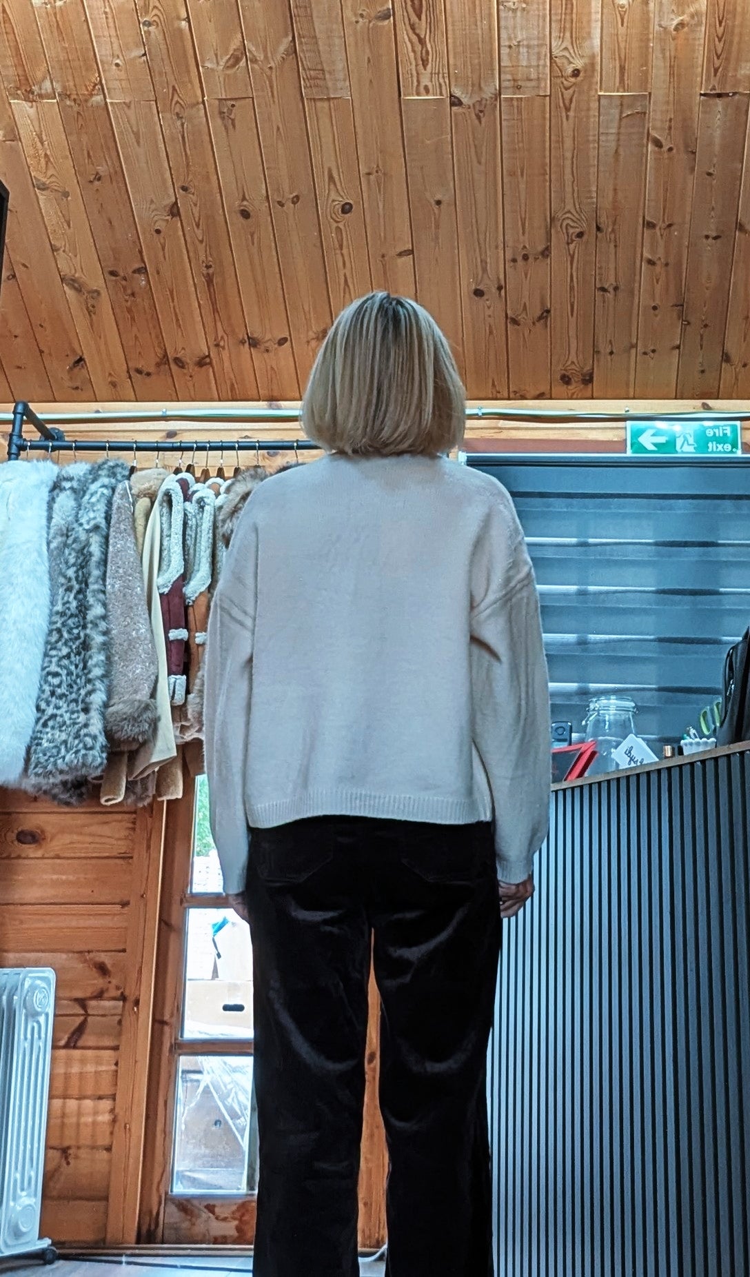Back view of Fran cream cardigan showing the plain knit back and dropped shoulders