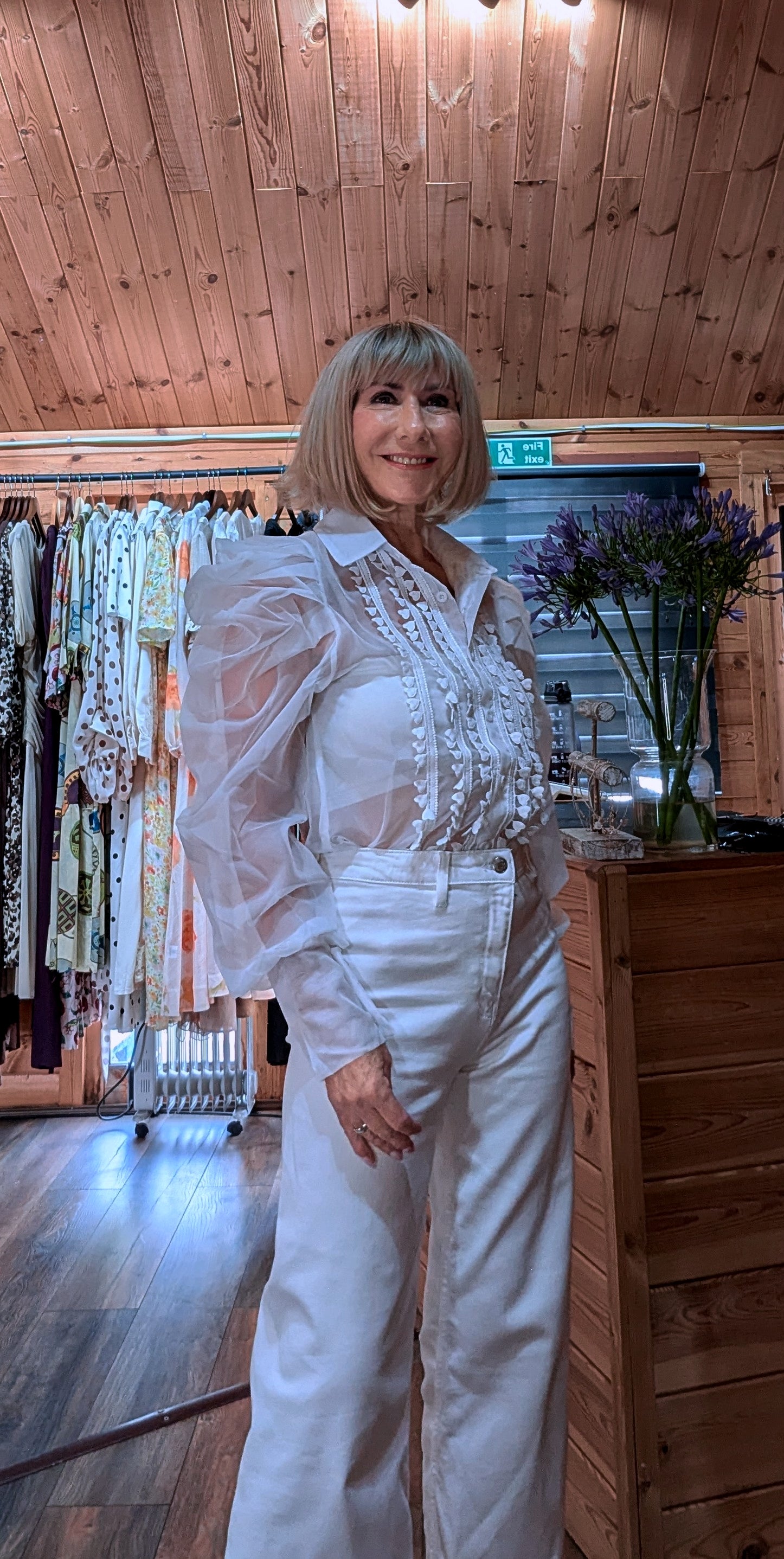 Close-up of the Lucille blouse showing the collar, buttons and embroidered front detail.