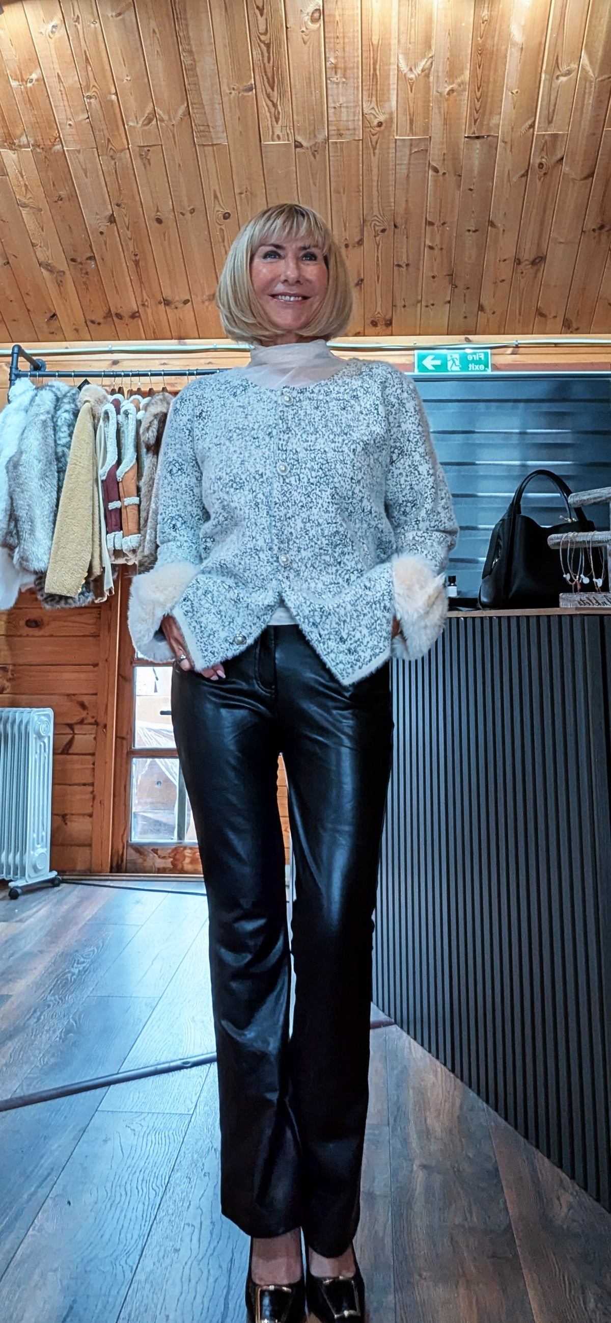 Front view of Liv white cardigan showing the textured knit and fluffy white cuffs