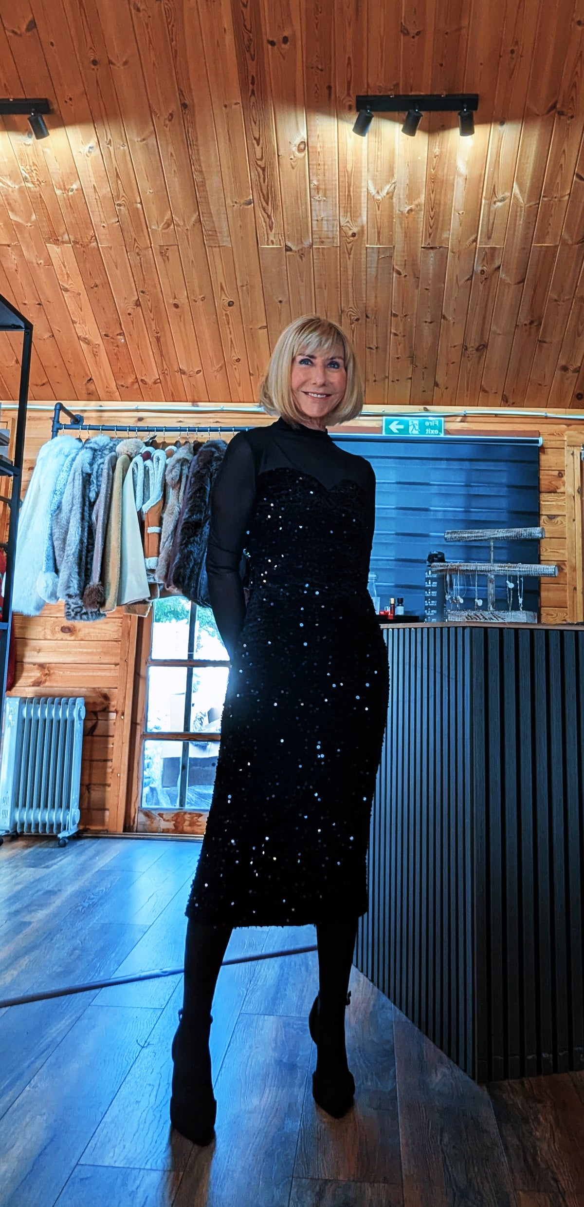 Di wearing the Audrey black sequin midi dress with sheer long sleeves, black tights and ankle boots.
