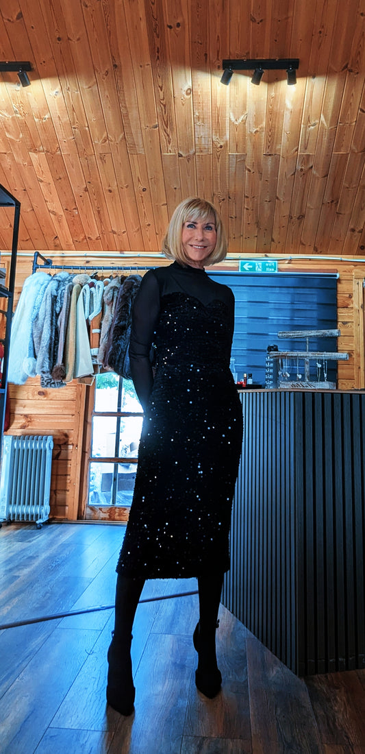 Di wearing the Audrey black sequin midi dress with sheer long sleeves, black tights and ankle boots.