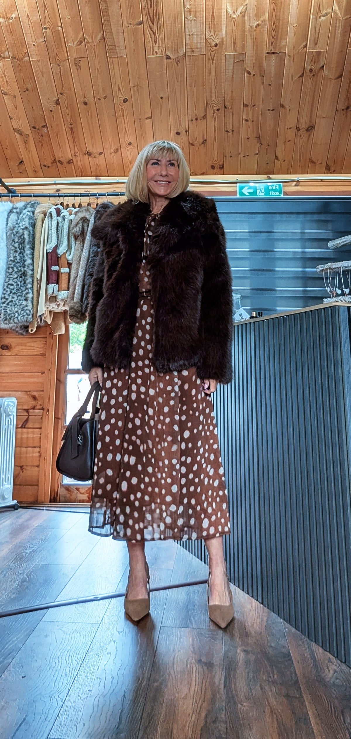 Dorothy chocolate spot-print midi dress styled with the Bella chocolate faux fur jacket, a black handbag and neutral heels