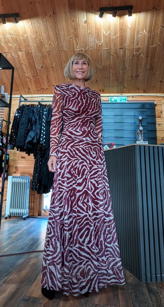 Di modelling the Waverley burgundy animal print maxi dress, shown full length in the boutique