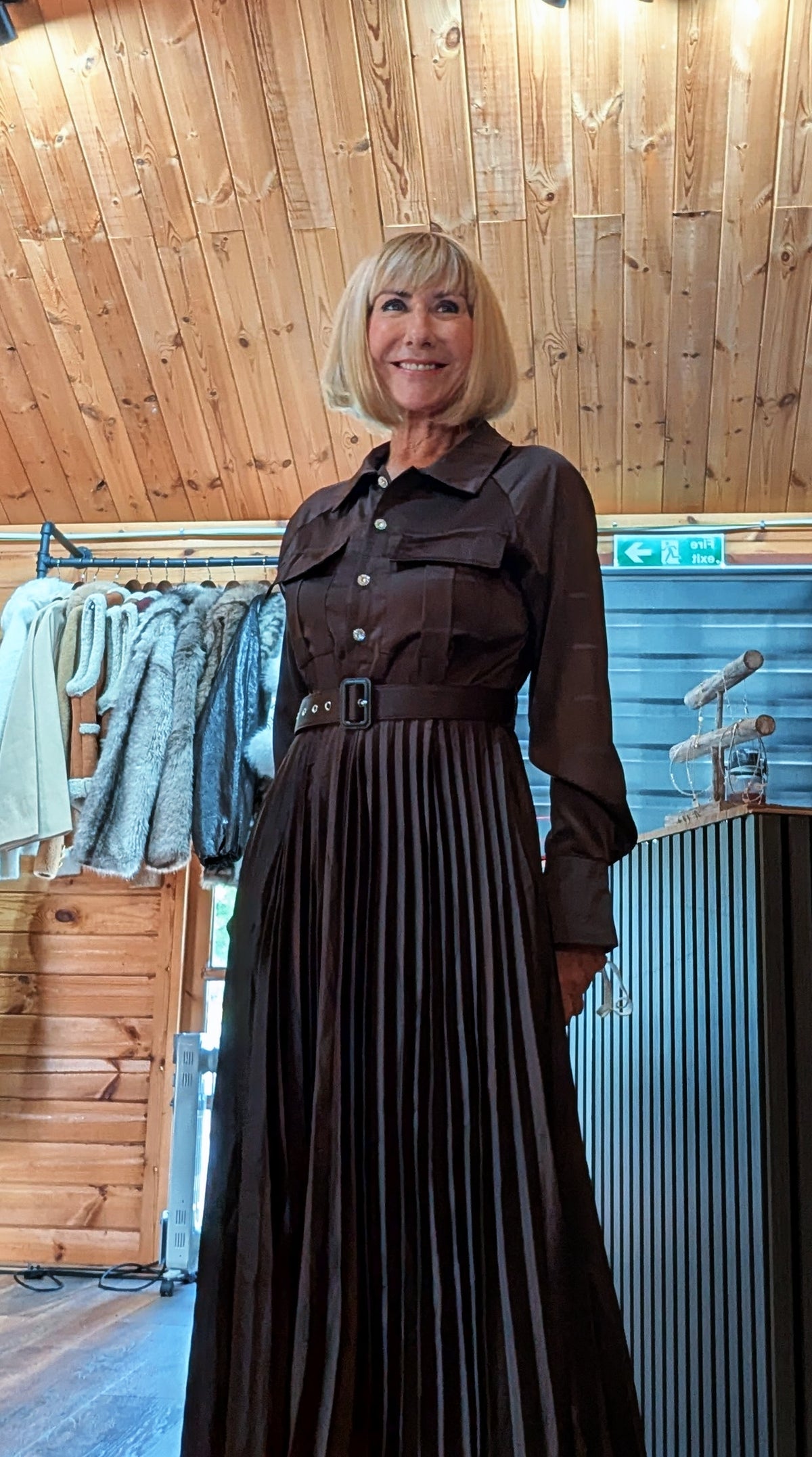 Side view of the Meryl long-sleeved chocolate maxi dress with pleated skirt
