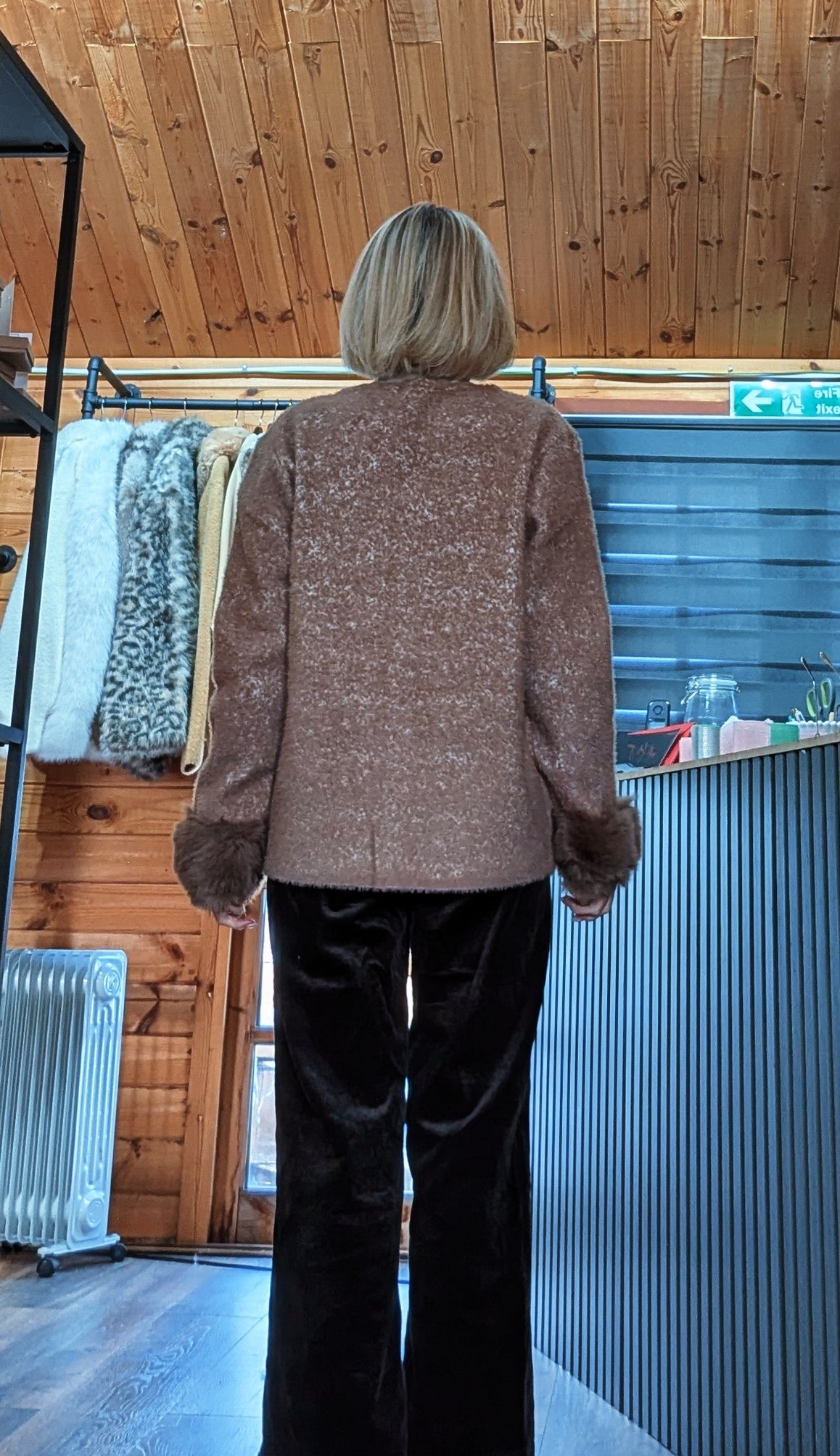 Back view of Liv chocolate cardigan showing the plain back shape and brown faux fur cuffs