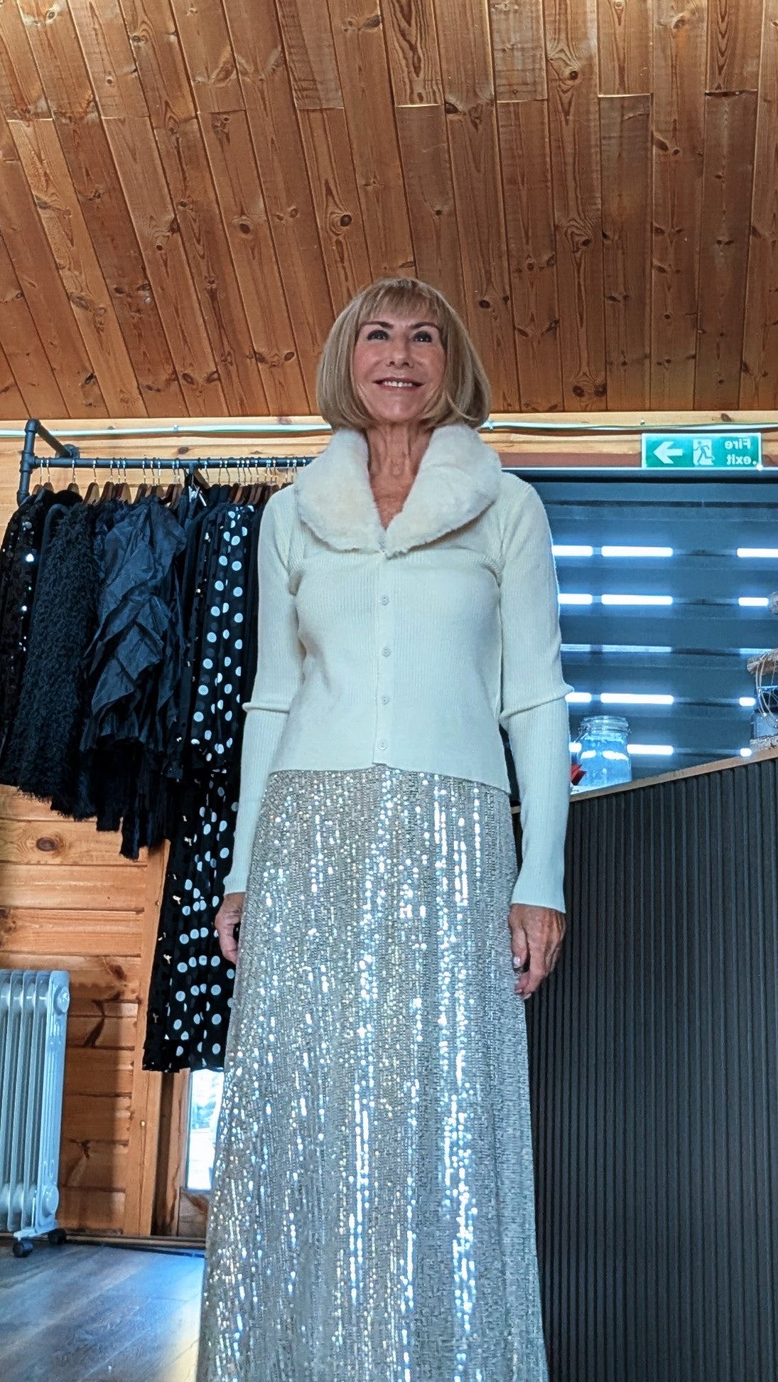 Closer front view of Cher skirt showing the shimmering sequins beneath a cream knit top