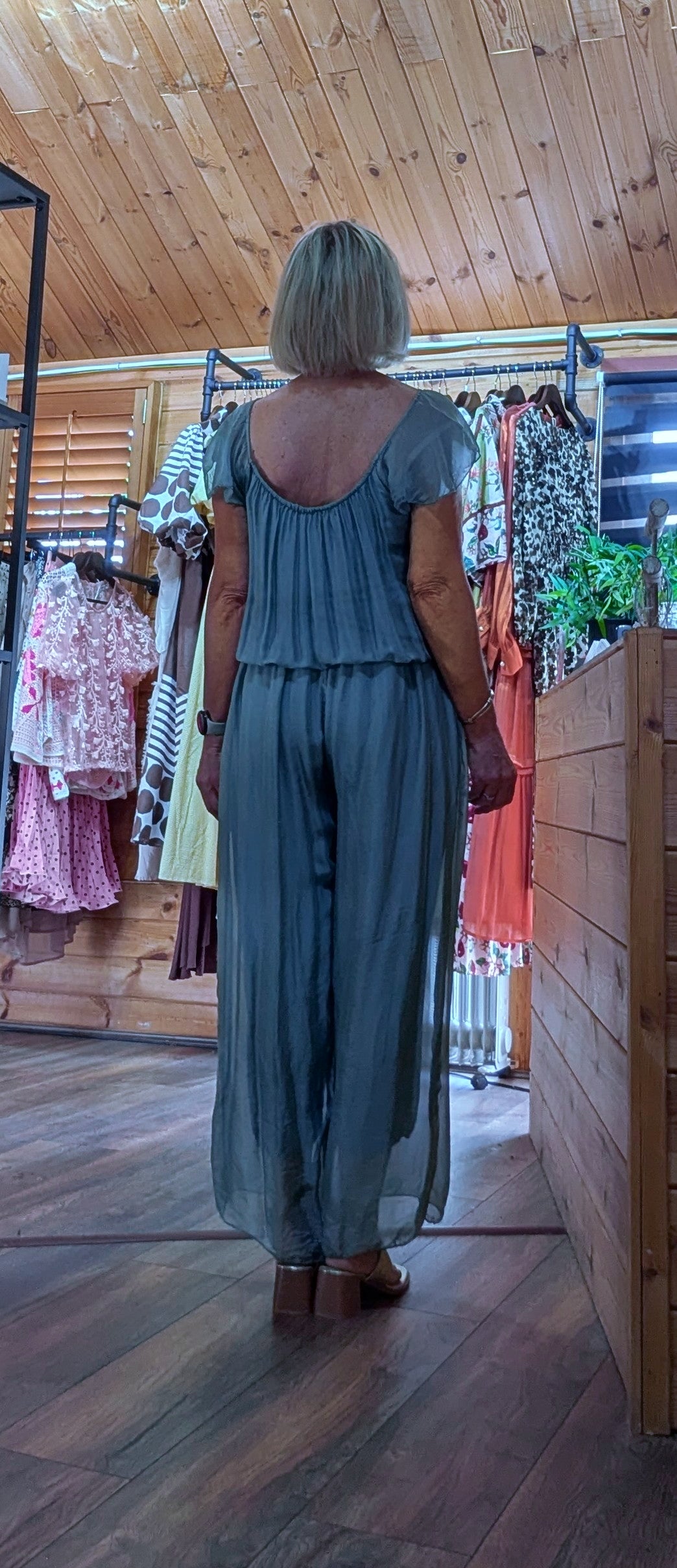 Rear view of the Jess aqua silk blend jumpsuit with a soft draped silhouette, elasticated waist and wide-leg design.
