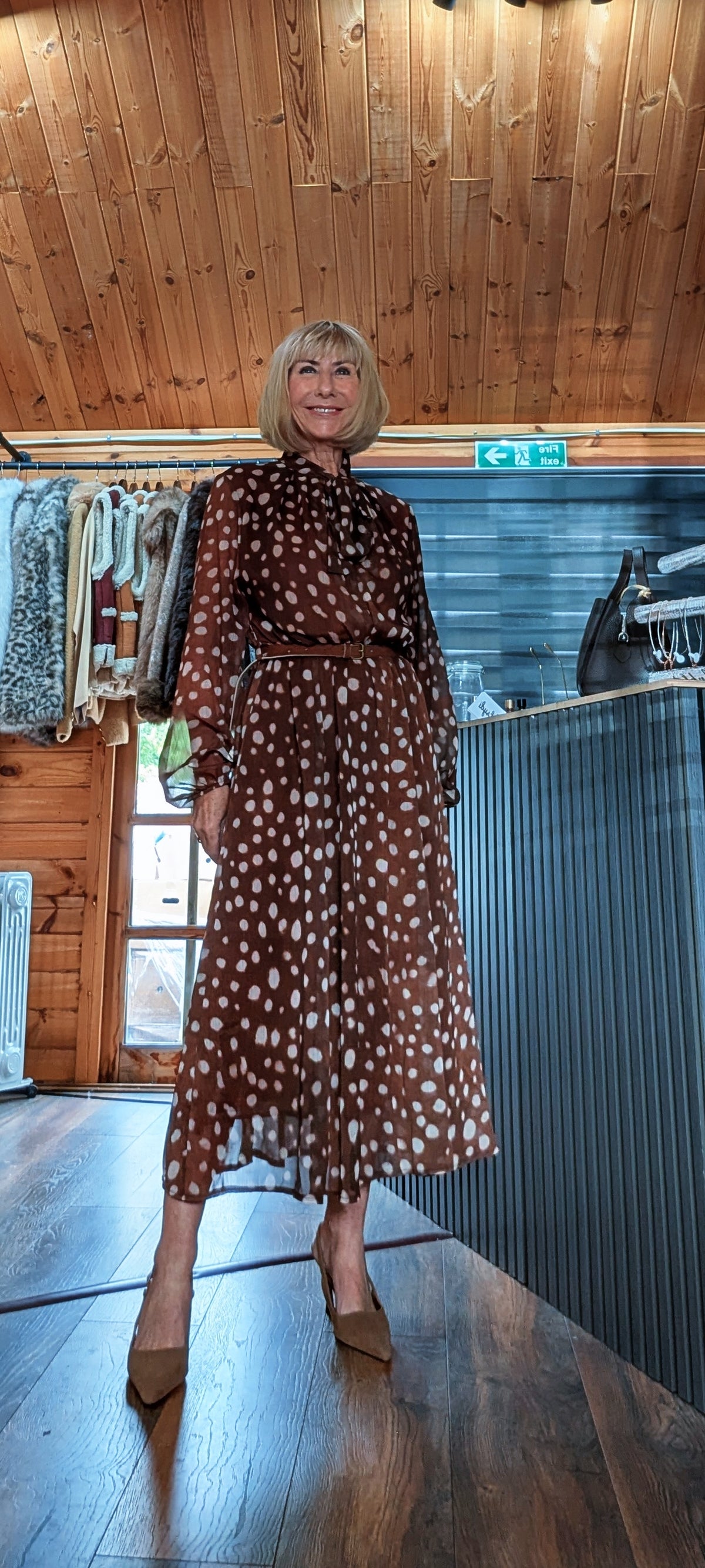 Dorothy chocolate dress styled with a black handbag on the shoulder