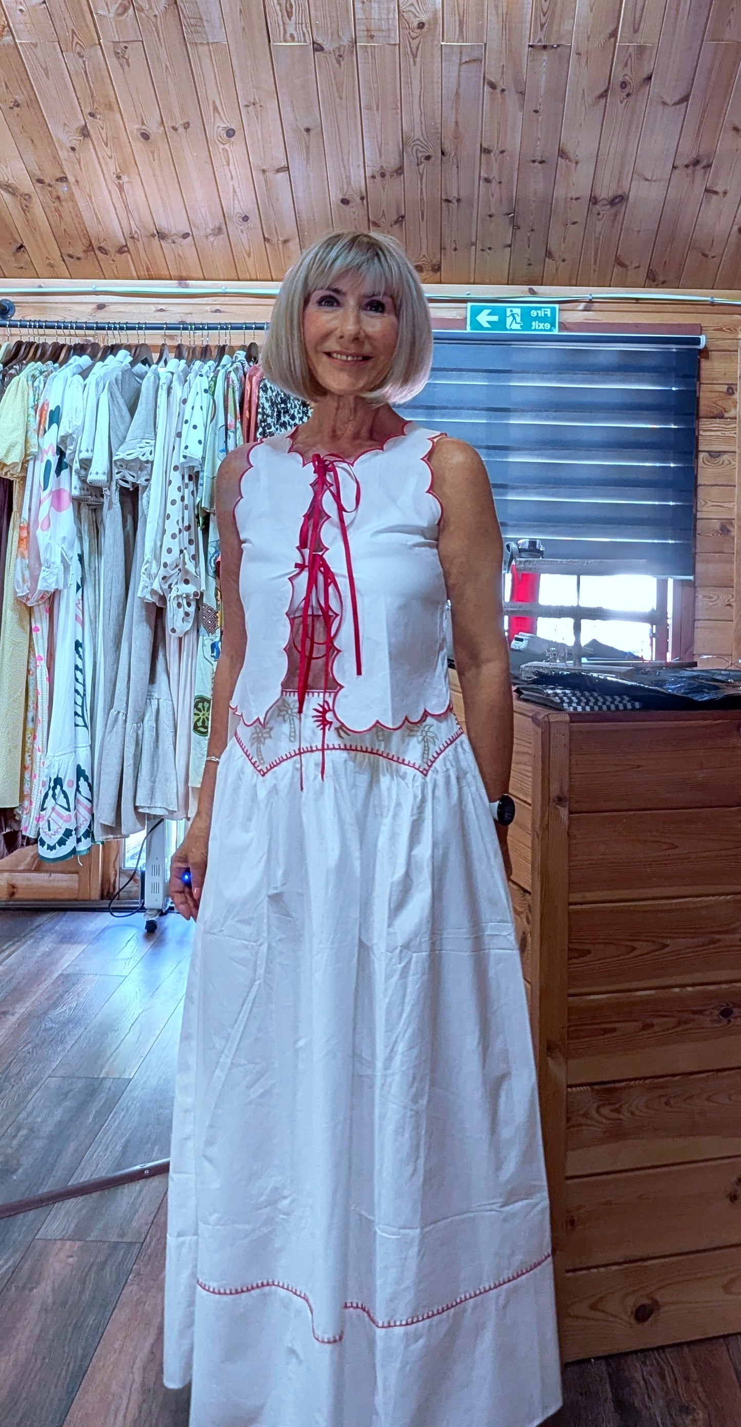 Three-quarter view of the Iris white embroidered cotton co-ord set featuring a sleeveless top with scalloped edging and a coordinating maxi skirt.