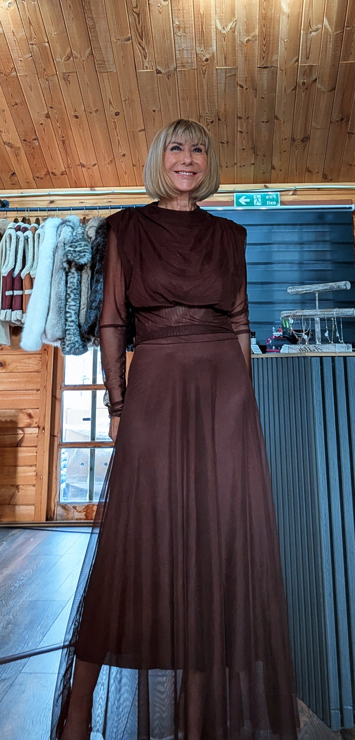 Harlow chocolate skirt set showing the draped high-neck top and long sheer sleeves