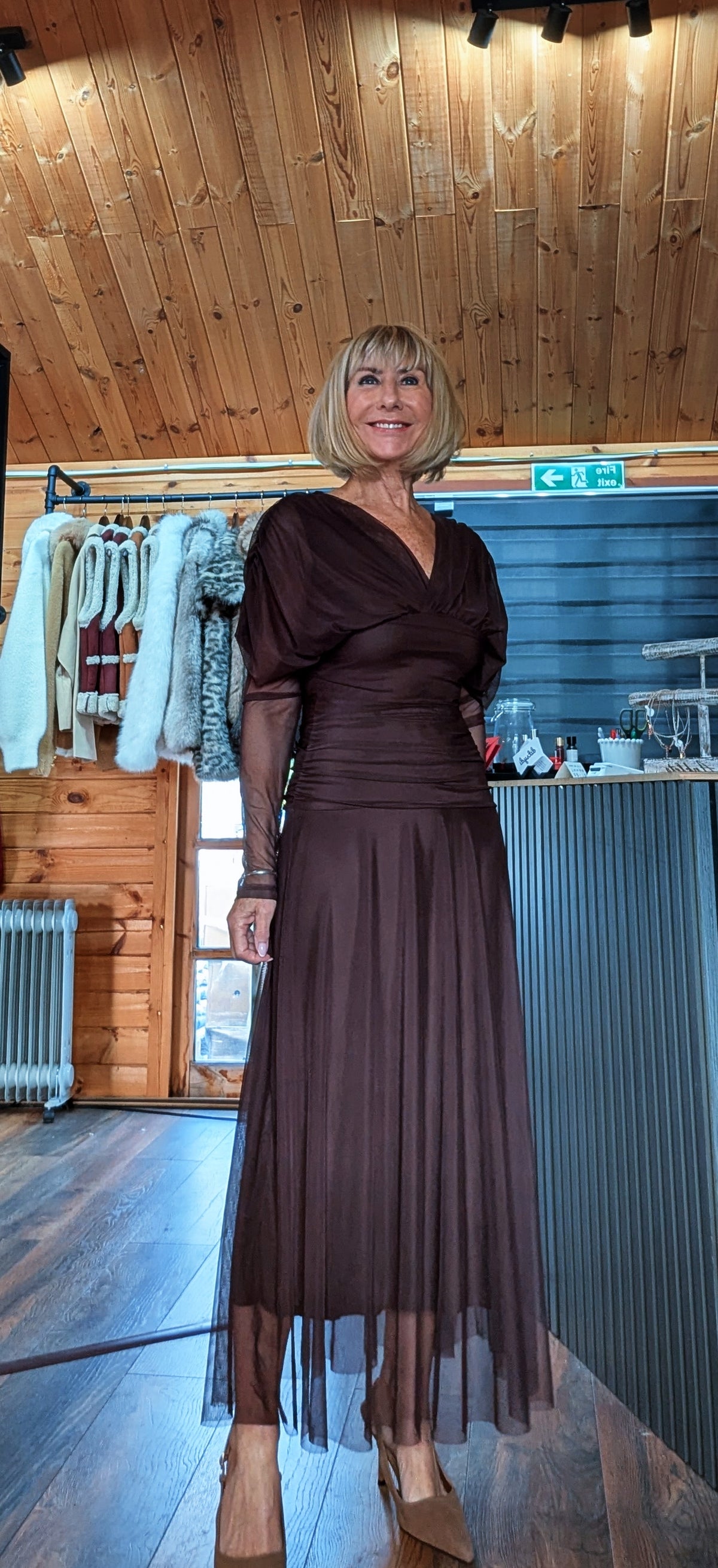 Luna chocolate V-neck dress styled with nude heels in a full-length boutique photo