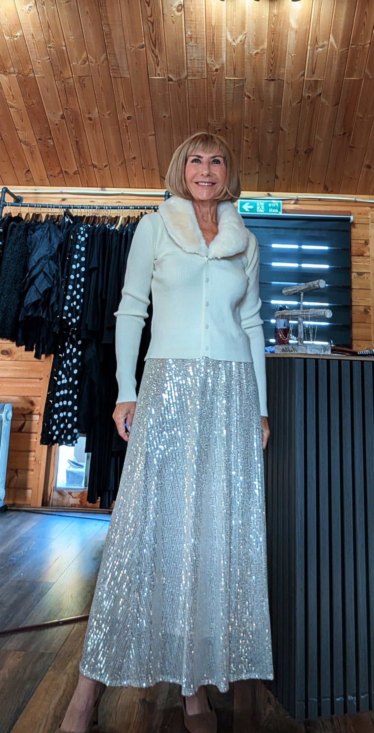 Front view of Cher champagne skirt showing the sparkling fabric and flowing silhouette