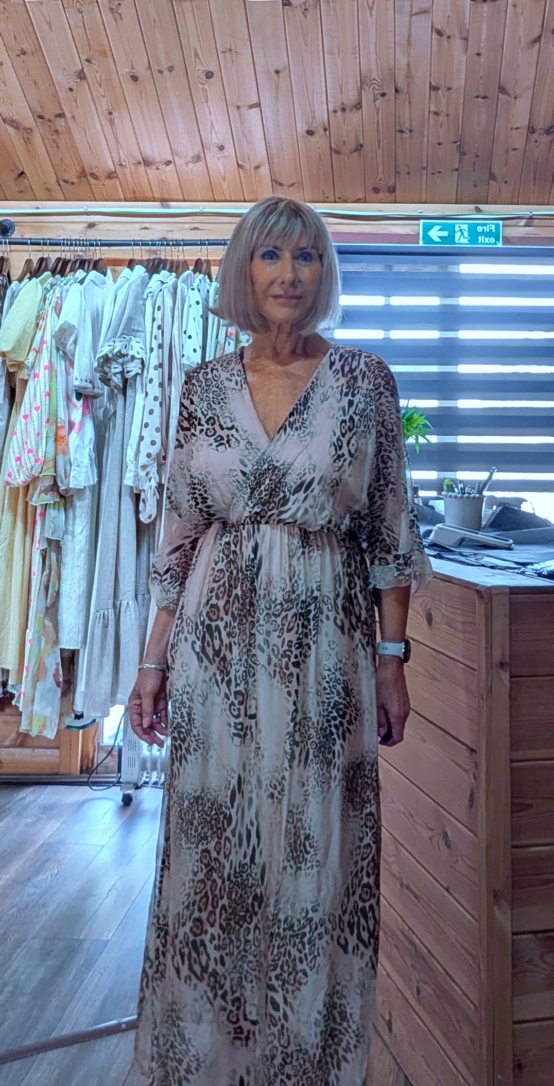 animal print silk blend maxi dress with a wrap-effect neckline and three-quarter length sleeves.