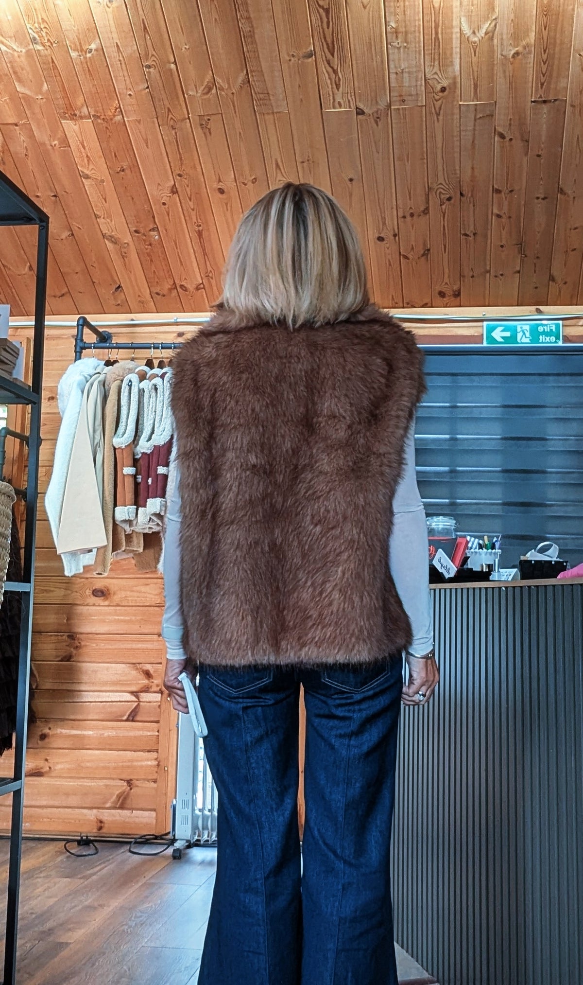 Back view of coco sleeveless faux fur gilet in chocolate brown